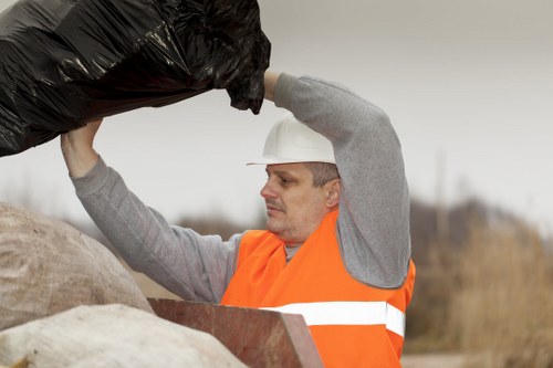 Worker inspecting waste container with checklist